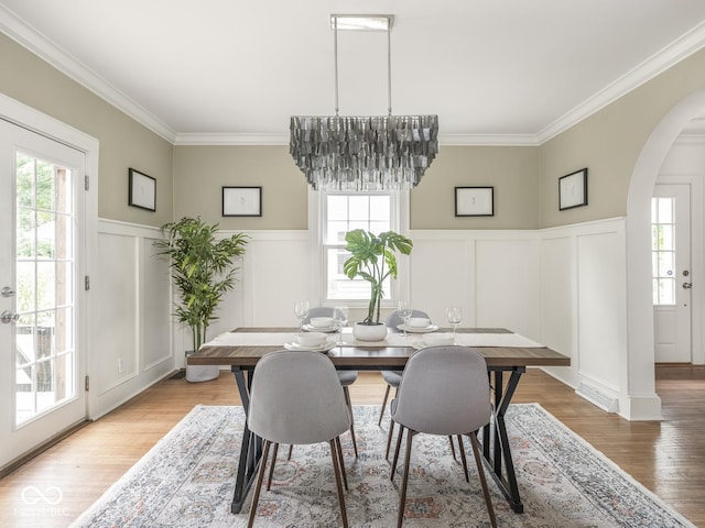 4455 Central Ave, Indianapolis, IN 46205 - dining area with a decorative wall, arched walkways, healthy amount of natural light, ornamental molding, and wainscoting