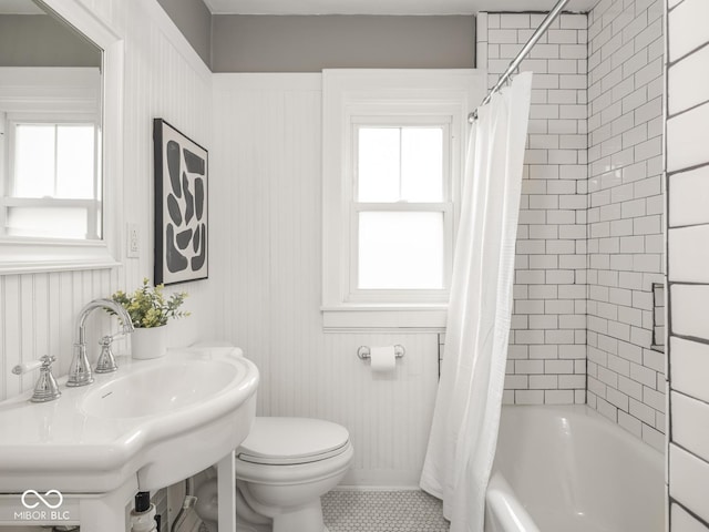 4455 Central Ave, Indianapolis, IN 46205 - bathroom with toilet, shower / bathtub combination with curtain, tile patterned floors, and a sink