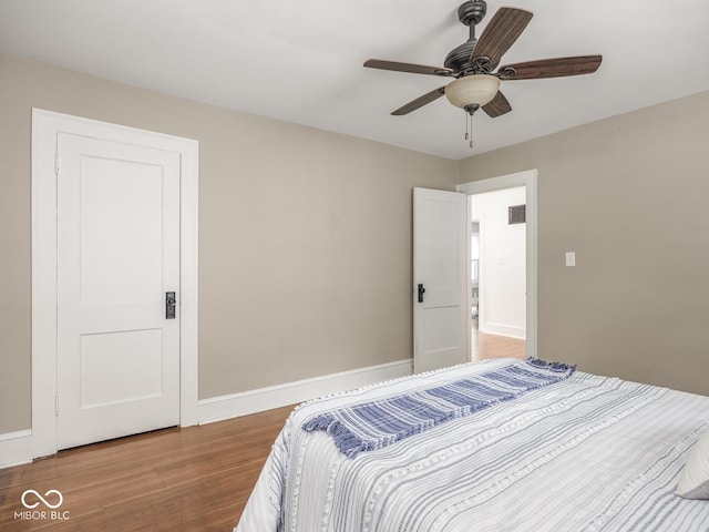 4455 Central Ave, Indianapolis, IN 46205 - bedroom with wood finished floors, baseboards, and ceiling fan