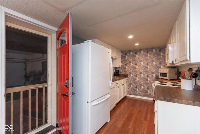 2766 Del Prado Dr Unit 6, Indianapolis, IN 46227 - kitchen with white appliances, dark countertops, white cabinetry, backsplash, and dark wood-style flooring