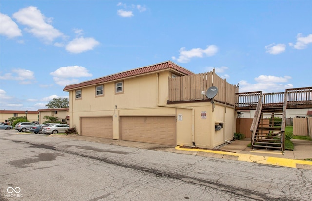 2766 Del Prado Dr Unit 6, Indianapolis, IN 46227 - view of front of home with stairway, stucco siding, and a garage