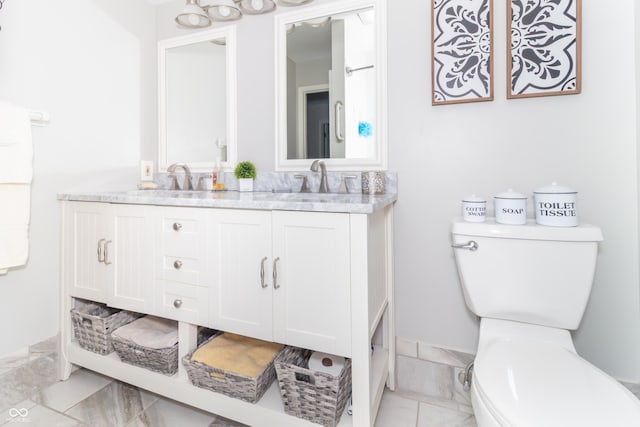12014 Briar Way Center Dr, Indianapolis, IN 46126 - bathroom featuring marble look tiles, toilet, and double vanity