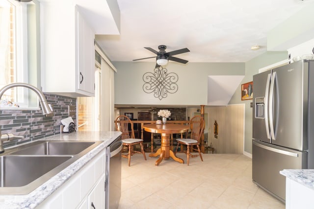 12014 Briar Way Center Dr, Indianapolis, IN 46126 - kitchen featuring appliances with stainless steel finishes, a sink, a ceiling fan, backsplash, and white cabinets