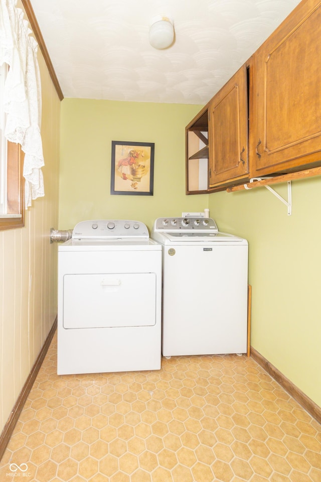 12014 Briar Way Center Dr, Indianapolis, IN 46126 - washroom featuring separate washer and dryer, cabinet space, and baseboards