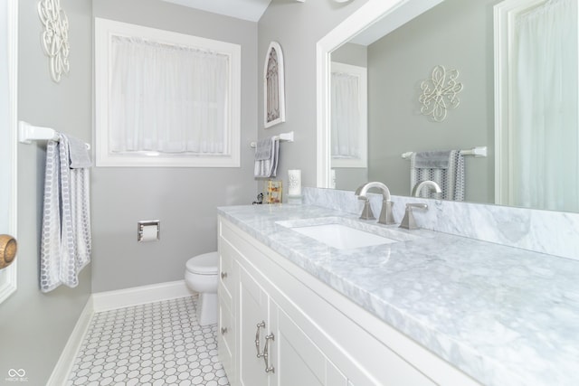 12014 Briar Way Center Dr, Indianapolis, IN 46126 - bathroom with baseboards, vanity, toilet, and tile patterned floors