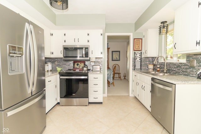 12014 Briar Way Center Dr, Indianapolis, IN 46126 - kitchen featuring appliances with stainless steel finishes, a sink, light countertops, tasteful backsplash, and white cabinetry
