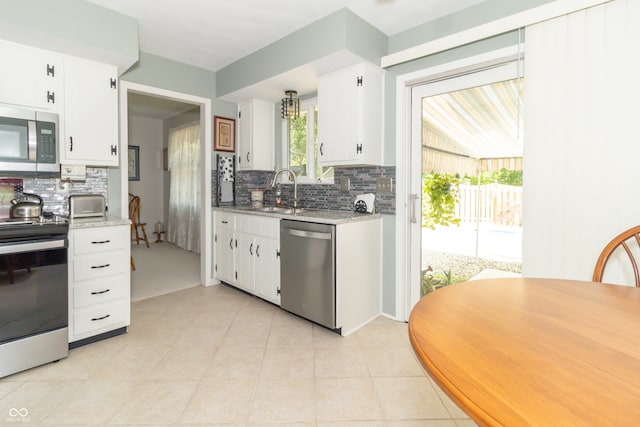 12014 Briar Way Center Dr, Indianapolis, IN 46126 - kitchen with appliances with stainless steel finishes, a sink, backsplash, white cabinets, and plenty of natural light