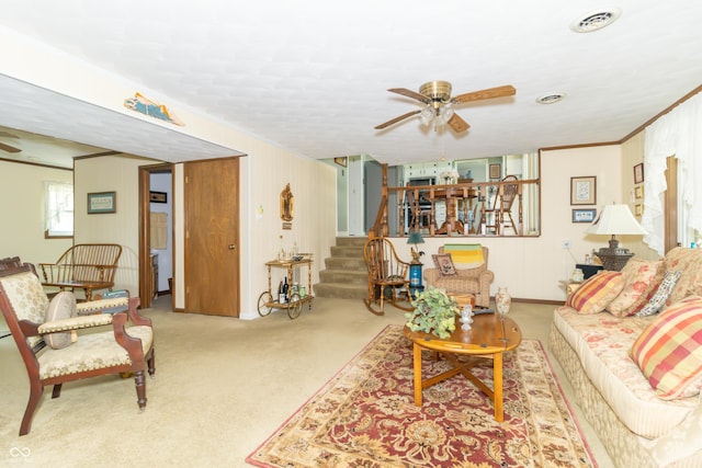 12014 Briar Way Center Dr, Indianapolis, IN 46126 - carpeted living room with ornamental molding, ceiling fan, stairway, and baseboards