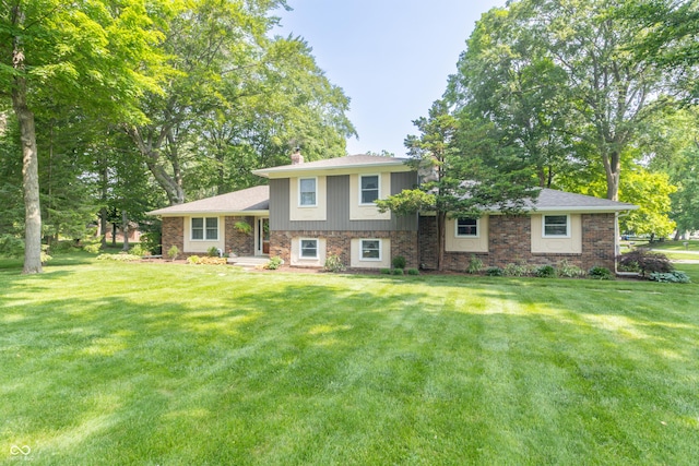 12014 Briar Way Center Dr, Indianapolis, IN 46126 - tri-level home with a front lawn, a chimney, and brick siding