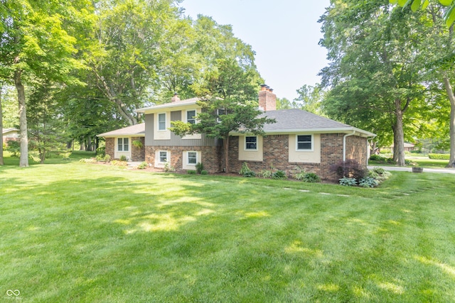 12014 Briar Way Center Dr, Indianapolis, IN 46126 - tri-level home featuring a chimney, a front lawn, and brick siding