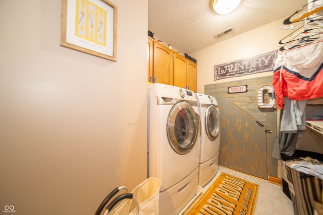 1145 Forest Commons Dr, Avon, IN 46123 - laundry room with cabinet space, separate washer and dryer, and a textured ceiling