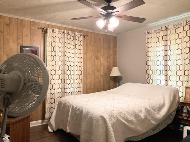 2032 N Auburn St, Speedway, IN 46224 - bedroom featuring wooden walls, wood finished floors, ornamental molding, a textured ceiling, and baseboards