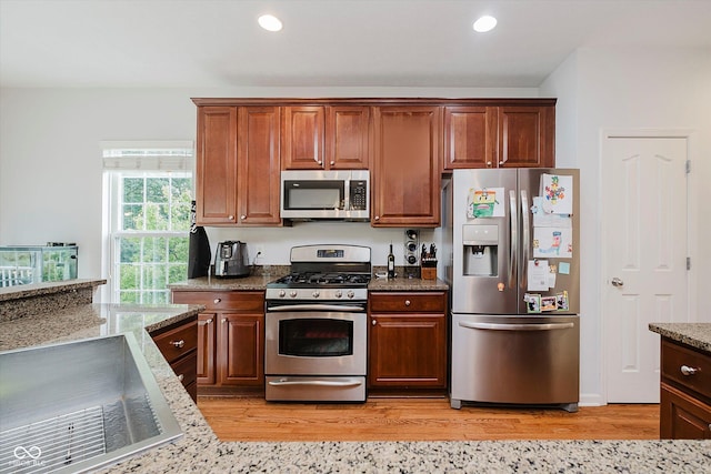 755 Ivy Ln, Carmel, IN 46032 - kitchen with stainless steel appliances, light stone counters, light wood-style floors, and recessed lighting