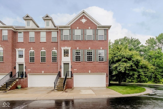 755 Ivy Ln, Carmel, IN 46032 - view of front facade with a garage, brick siding, driveway, and stairs