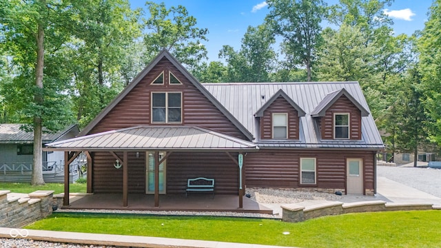 2540 S Annapolis Rd, Rockville, IN 47872 - view of front of home featuring faux log siding, a front yard, metal roof, and a patio area