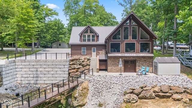 2540 S Annapolis Rd, Rockville, IN 47872 - view of front of home featuring stone siding, metal roof, and stairway