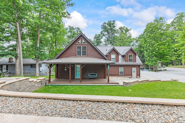2540 S Annapolis Rd, Rockville, IN 47872 - rustic home featuring faux log siding, a porch, a front yard, metal roof, and a standing seam roof