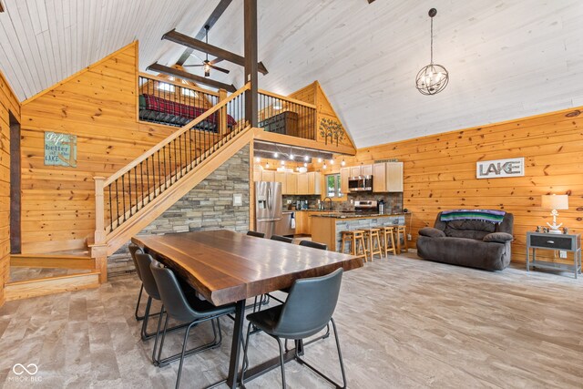 2540 S Annapolis Rd, Rockville, IN 47872 - dining room featuring high vaulted ceiling, wooden walls, stairs, ceiling fan, and a chandelier