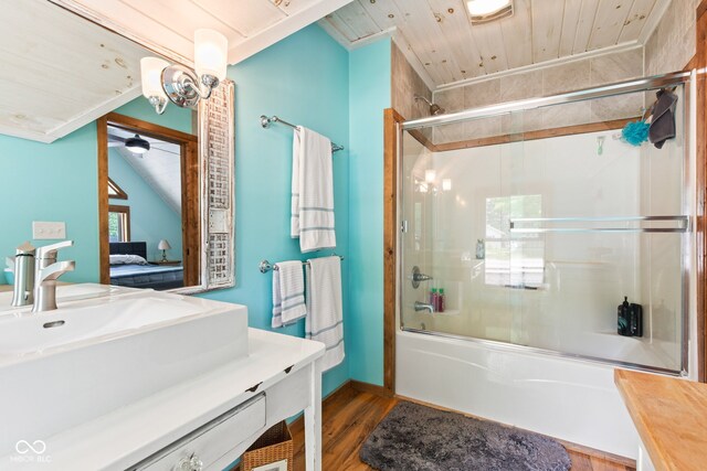 2540 S Annapolis Rd, Rockville, IN 47872 - ensuite bathroom featuring shower / bath combination with glass door, vanity, and wood finished floors