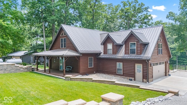 2540 S Annapolis Rd, Rockville, IN 47872 - view of front facade featuring faux log siding, concrete driveway, an attached garage, and a front lawn