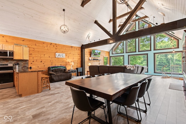 2540 S Annapolis Rd, Rockville, IN 47872 - dining room featuring healthy amount of natural light, high vaulted ceiling, light wood-style floors, beam ceiling, and wooden walls