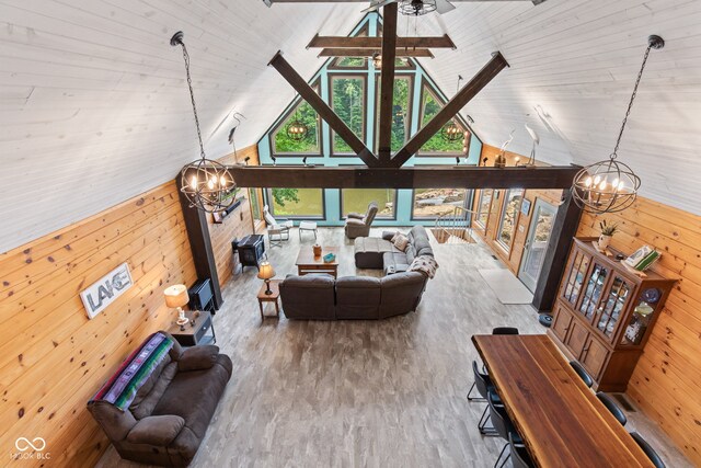 2540 S Annapolis Rd, Rockville, IN 47872 - living room with a chandelier, wood walls, high vaulted ceiling, wood finished floors, and ceiling fan