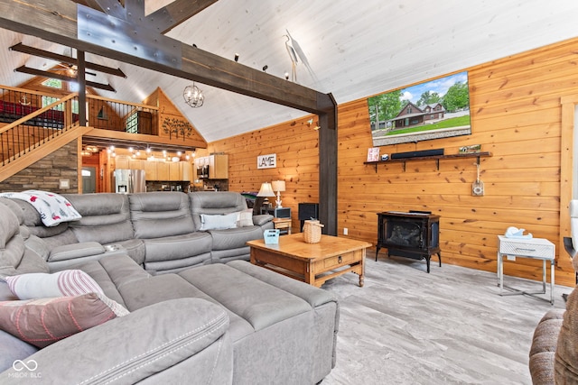 2540 S Annapolis Rd, Rockville, IN 47872 - living room featuring a wood stove, wood walls, stairs, beam ceiling, and high vaulted ceiling
