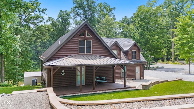 2540 S Annapolis Rd, Rockville, IN 47872 - view of front facade featuring central air condition unit, a porch, faux log siding, metal roof, and a standing seam roof