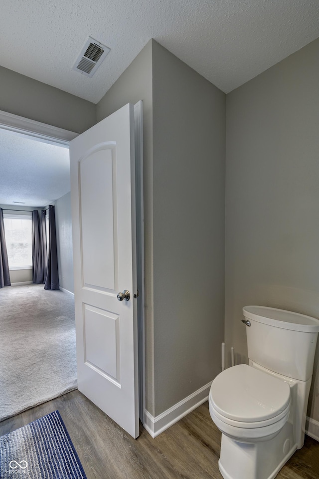 19187 Outer Bank Rd, Noblesville, IN 46062 - bathroom featuring wood finished floors, toilet, baseboards, and a textured ceiling