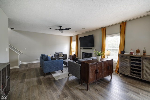 19187 Outer Bank Rd, Noblesville, IN 46062 - living room featuring ceiling fan, a textured ceiling, dark wood finished floors, baseboards, and stairs