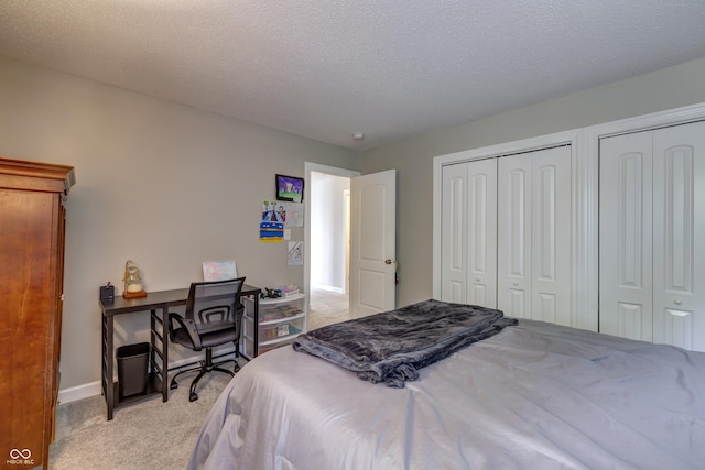 19187 Outer Bank Rd, Noblesville, IN 46062 - bedroom with light colored carpet, multiple closets, baseboards, and a textured ceiling