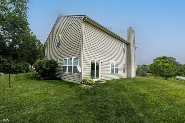 19187 Outer Bank Rd, Noblesville, IN 46062 - back of house featuring a chimney and a yard
