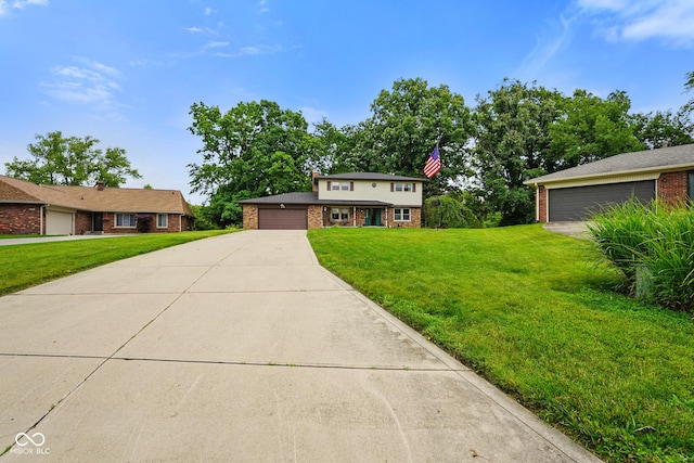 955 Wood Creek Pl, Greenwood, IN 46142 - view of front of property featuring brick siding, a front yard, and a garage