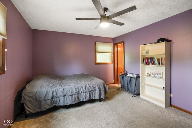 955 Wood Creek Pl, Greenwood, IN 46142 - carpeted bedroom with a textured ceiling, ceiling fan, and baseboards