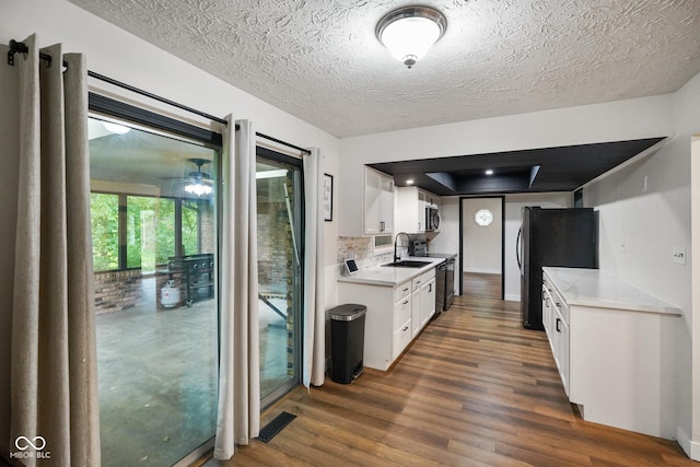 955 Wood Creek Pl, Greenwood, IN 46142 - kitchen with dark wood finished floors, a sink, light countertops, appliances with stainless steel finishes, and a textured ceiling