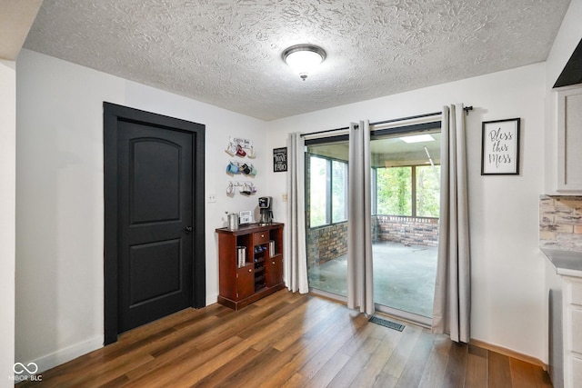 955 Wood Creek Pl, Greenwood, IN 46142 - unfurnished dining area with wood finished floors, a textured ceiling, and baseboards
