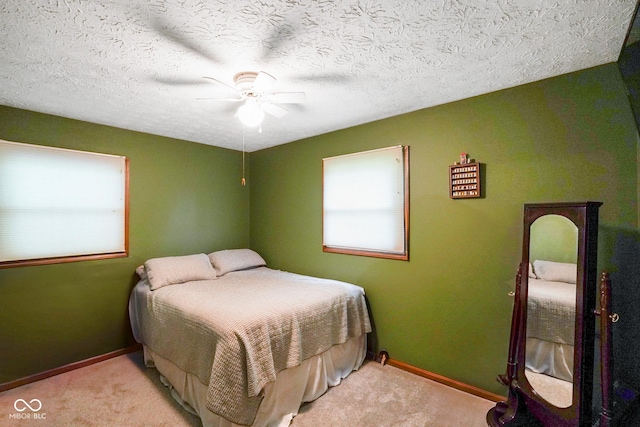 955 Wood Creek Pl, Greenwood, IN 46142 - carpeted bedroom with multiple windows, baseboards, and ceiling fan