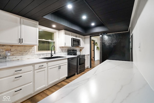 955 Wood Creek Pl, Greenwood, IN 46142 - kitchen with black microwave, a sink, stainless steel range with electric cooktop, wooden ceiling, and light wood-style floors