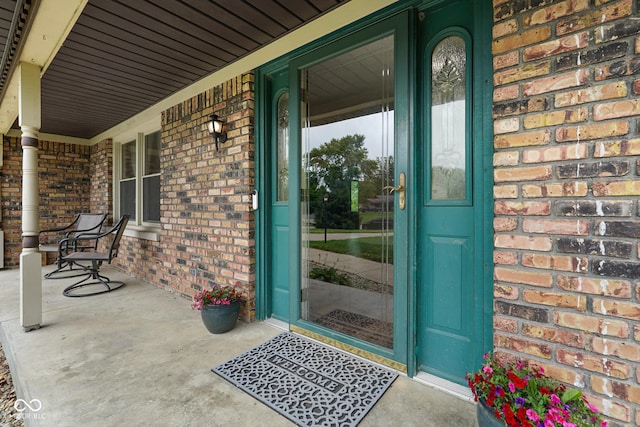 955 Wood Creek Pl, Greenwood, IN 46142 - view of exterior entry with covered porch and brick siding