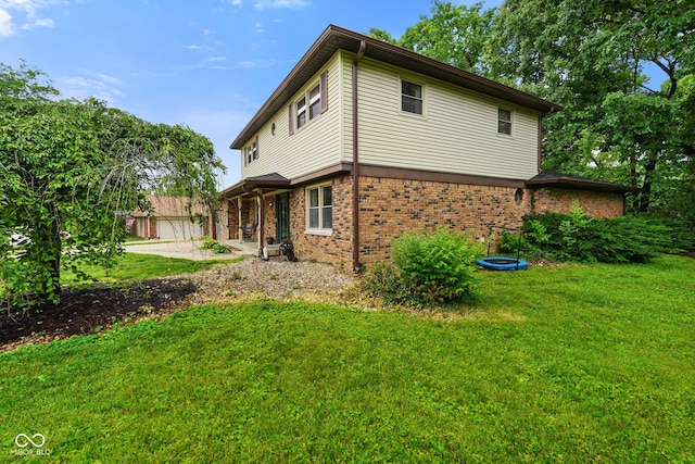 955 Wood Creek Pl, Greenwood, IN 46142 - rear view of house with brick siding and a yard