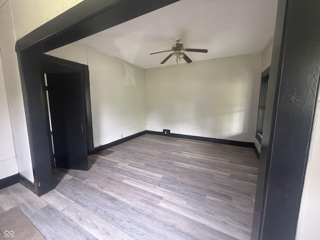 2826 Station St, Indianapolis, IN 46218 - spare room featuring ceiling fan, wood finished floors, and baseboards