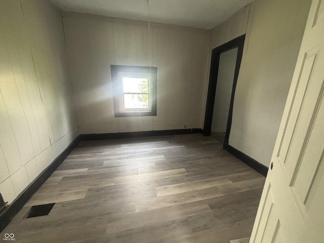 2826 Station St, Indianapolis, IN 46218 - empty room featuring wood finished floors and baseboards