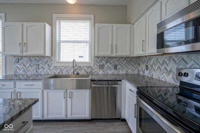 12382 Cool Winds Way, Fishers, IN 46037 - kitchen featuring stainless steel appliances, a sink, white cabinetry, and light stone countertops