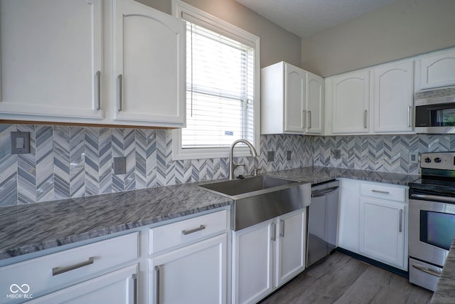 12382 Cool Winds Way, Fishers, IN 46037 - kitchen featuring stainless steel appliances, a sink, white cabinets, stone countertops, and dark wood finished floors