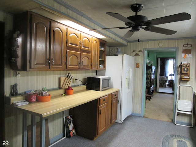 112 Orchard St, Waynetown, IN 47990 - kitchen featuring stainless steel microwave, light carpet, ceiling fan, white refrigerator with ice dispenser, and light countertops