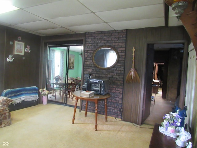 112 Orchard St, Waynetown, IN 47990 - carpeted living room featuring wood walls and a paneled ceiling
