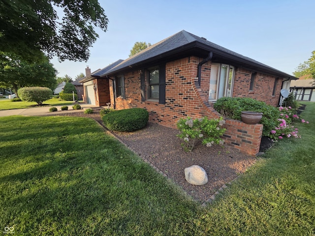 1201 Briarwood Dr, Brownsburg, IN 46112 - view of home's exterior featuring brick siding, a chimney, a yard, a garage, and concrete driveway