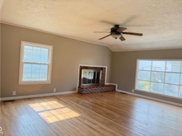 3100 Oak St, Terre Haute, IN 47803 - unfurnished living room featuring a ceiling fan, plenty of natural light, wood finished floors, and crown molding