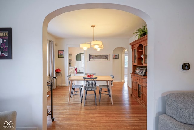 5435 E 10th St, Indianapolis, IN 46219 - dining area with arched walkways and light wood-style flooring