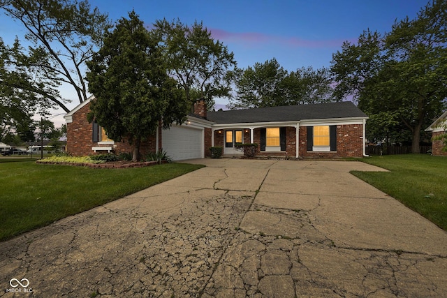 3148 Arbutus Dr, Indianapolis, IN 46224 - view of front of home featuring brick siding, a chimney, driveway, and an attached garage